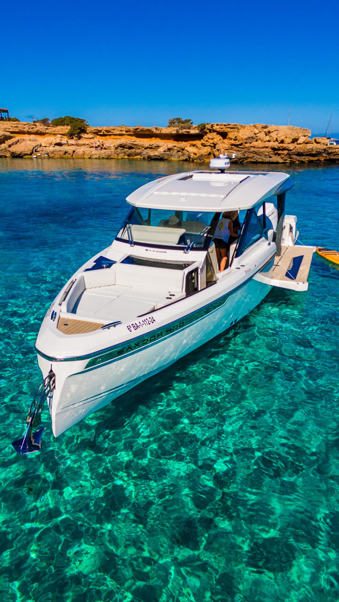 Saxdor 400 anchored in a turquoise cove off Ibiza