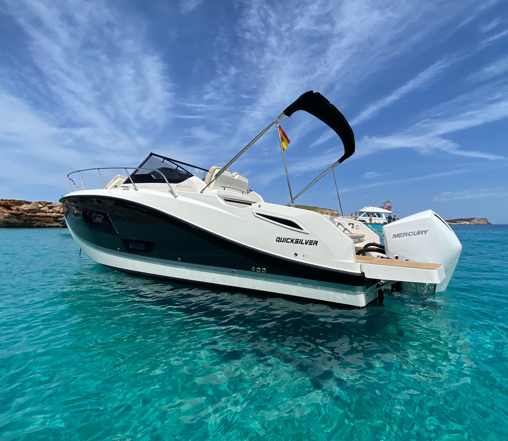 Thunder Quicksilver 875 Sundeck anchored in a turquoise cove off Ibiza